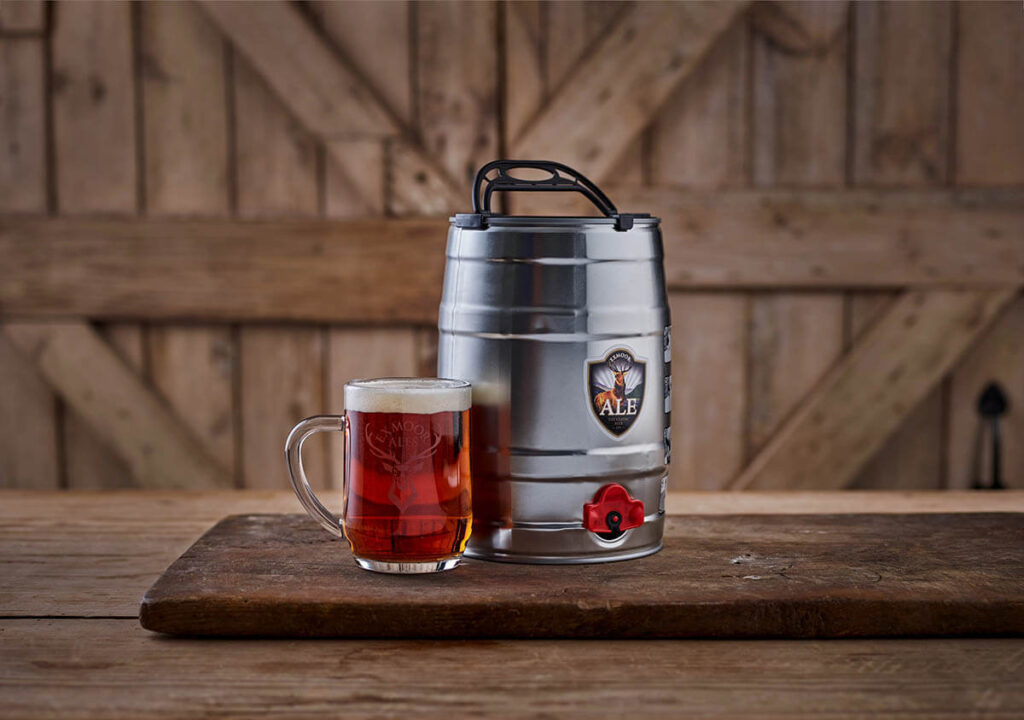 Mini cask of Exmoor Ale with a full tankard pint glass